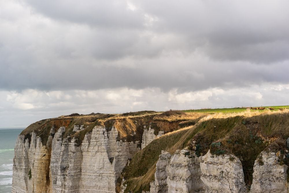 a group of cliffs on the edge of the ocean