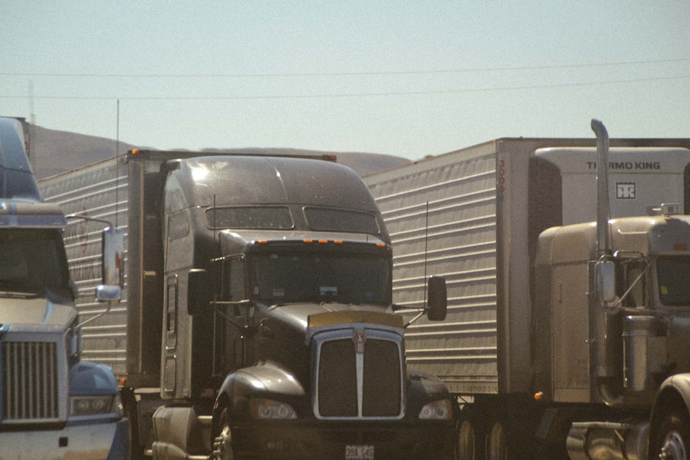 a couple of semi trucks parked next to each other