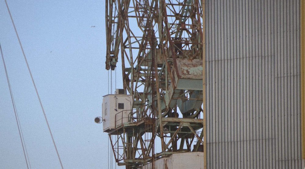 a large crane sitting next to a tall building