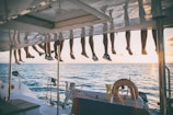 a bunch of shoes hanging from a line on a boat