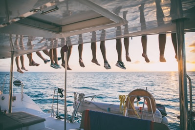 a bunch of shoes hanging from a line on a boat