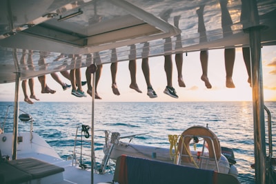 a bunch of shoes hanging from a line on a boat