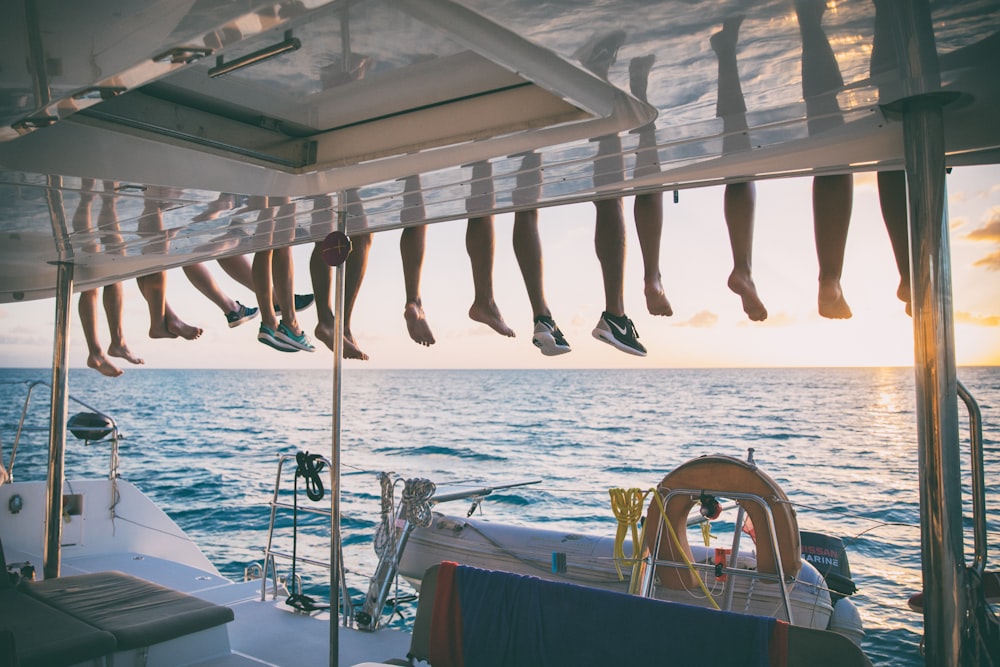 a bunch of shoes hanging from a line on a boat