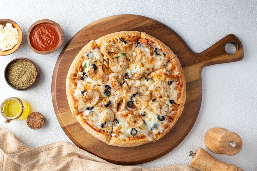 a pizza sitting on top of a wooden cutting board