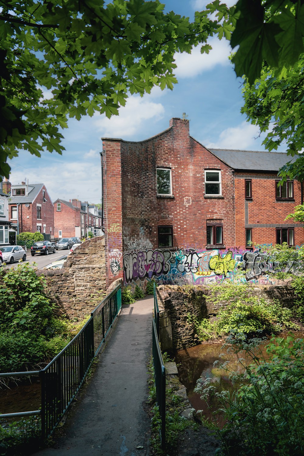 a brick building with graffiti on the side of it