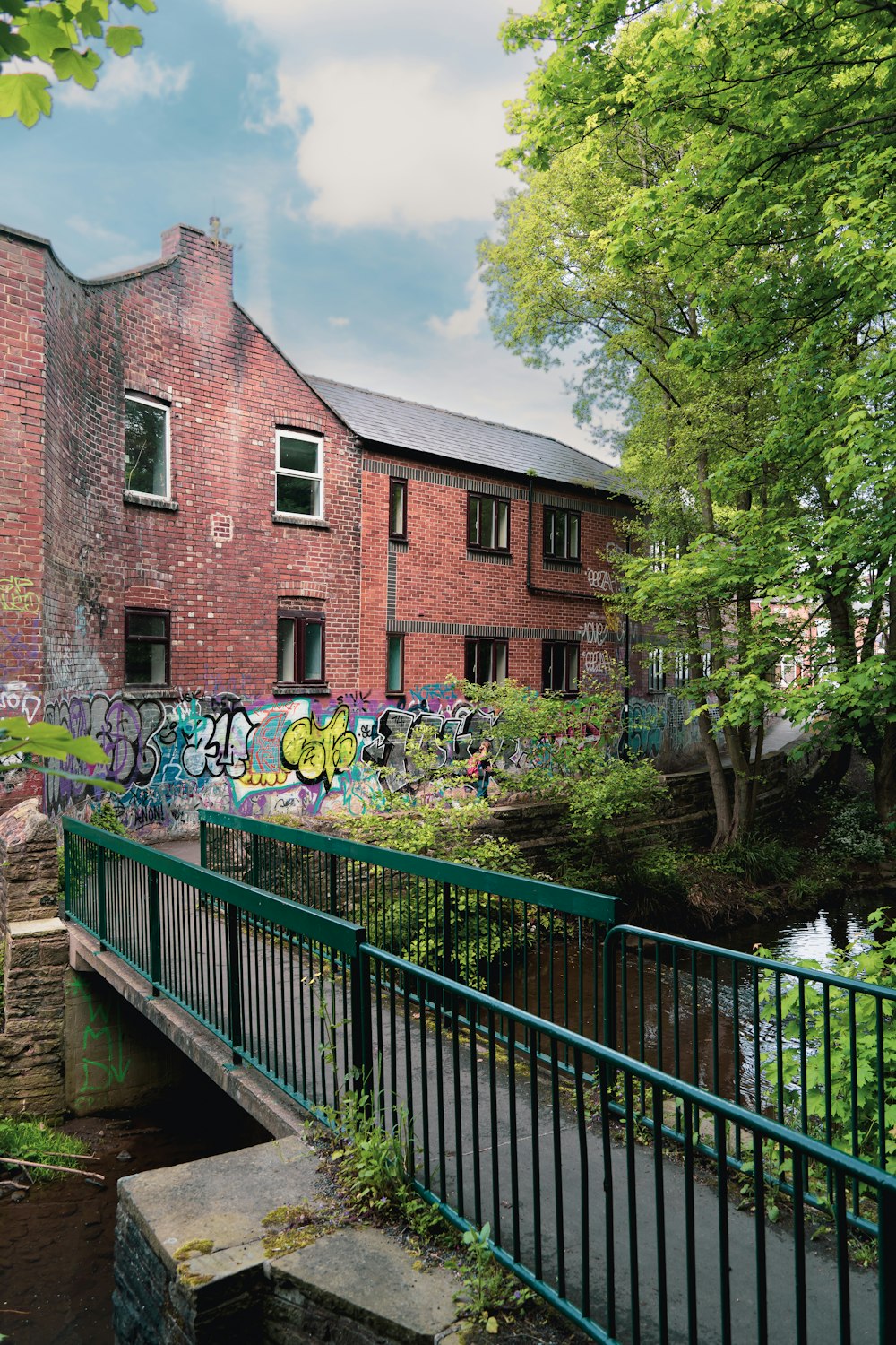 a brick building with graffiti on the side of it