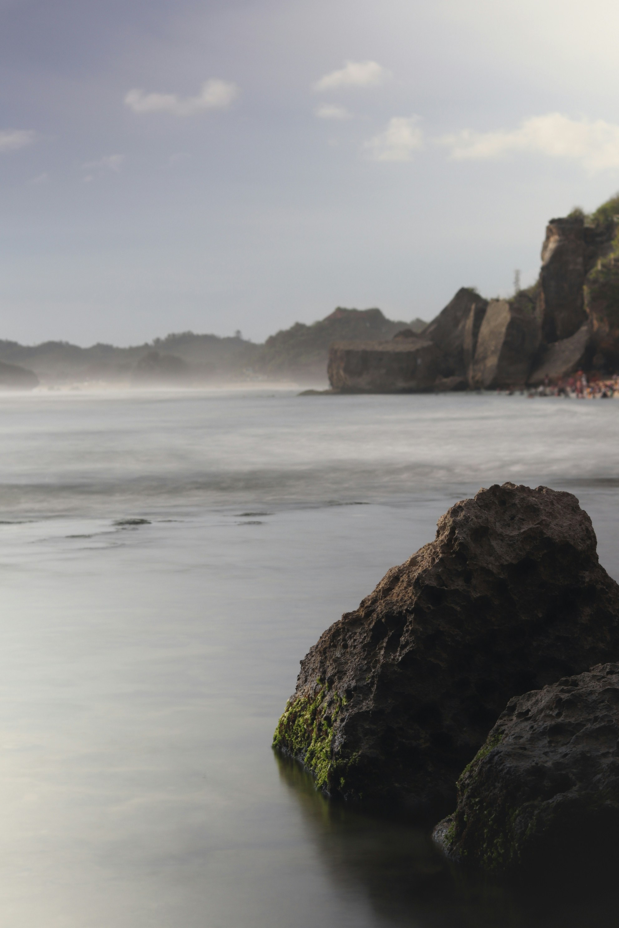 A large rock sitting on top of a sandy beach photo – Free Yogyakarta ...
