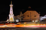 a very tall clock tower towering over a city at night