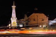 Close-up of the Tugu Petir monument bathed in warm sunlight, symbolizing the spirit of unity.