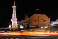 a very tall clock tower towering over a city at night