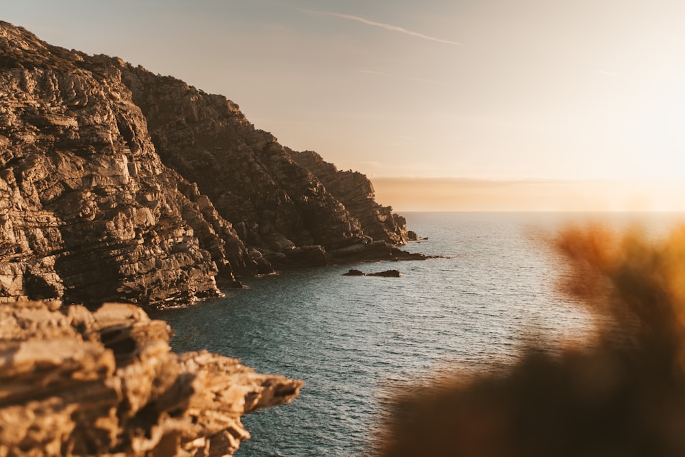 a view of a body of water near a rocky cliff