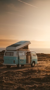 A cozy camper van parked in a scenic Spanish countryside at sunset.
