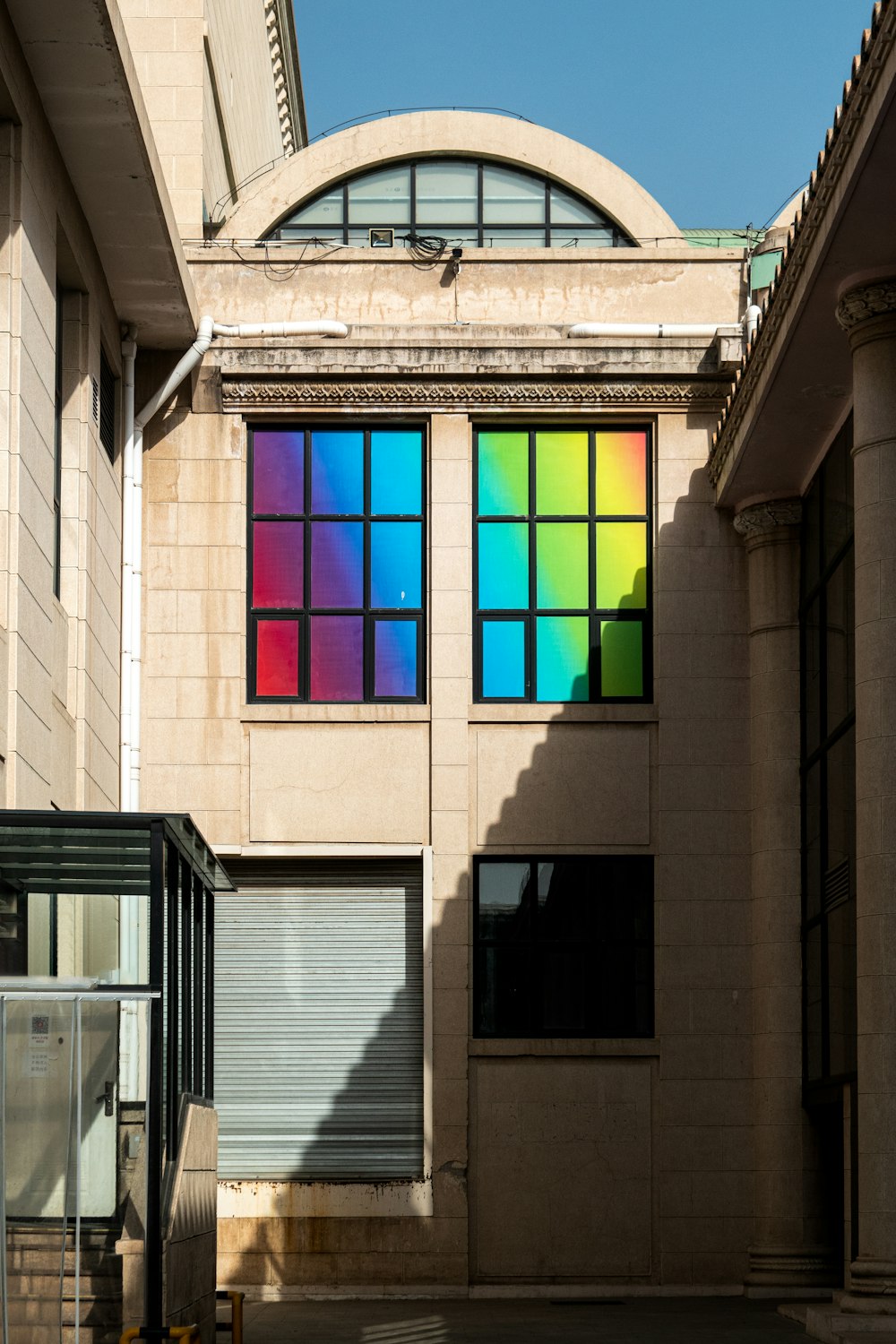 a building with a rainbow colored window on the side of it