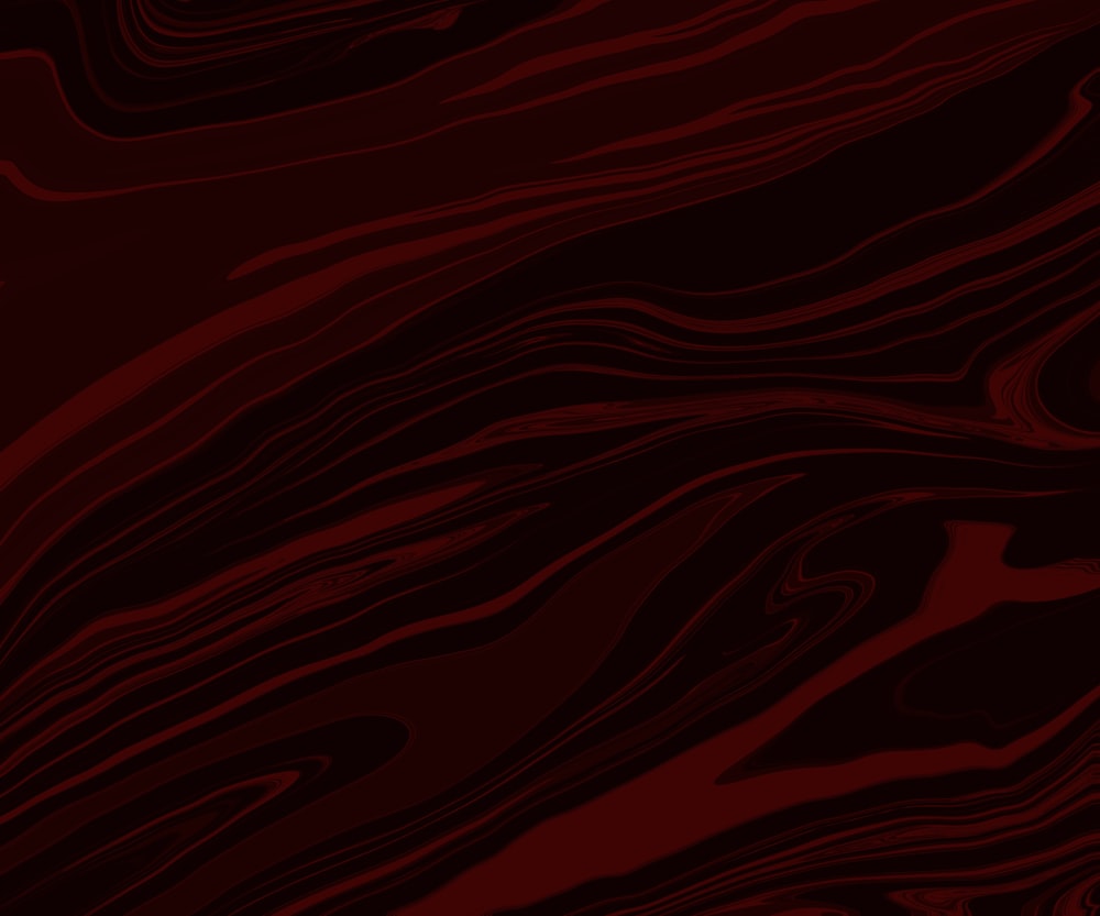 a red and black abstract background with wavy lines