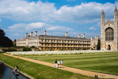 a group of people walking across a lush green field