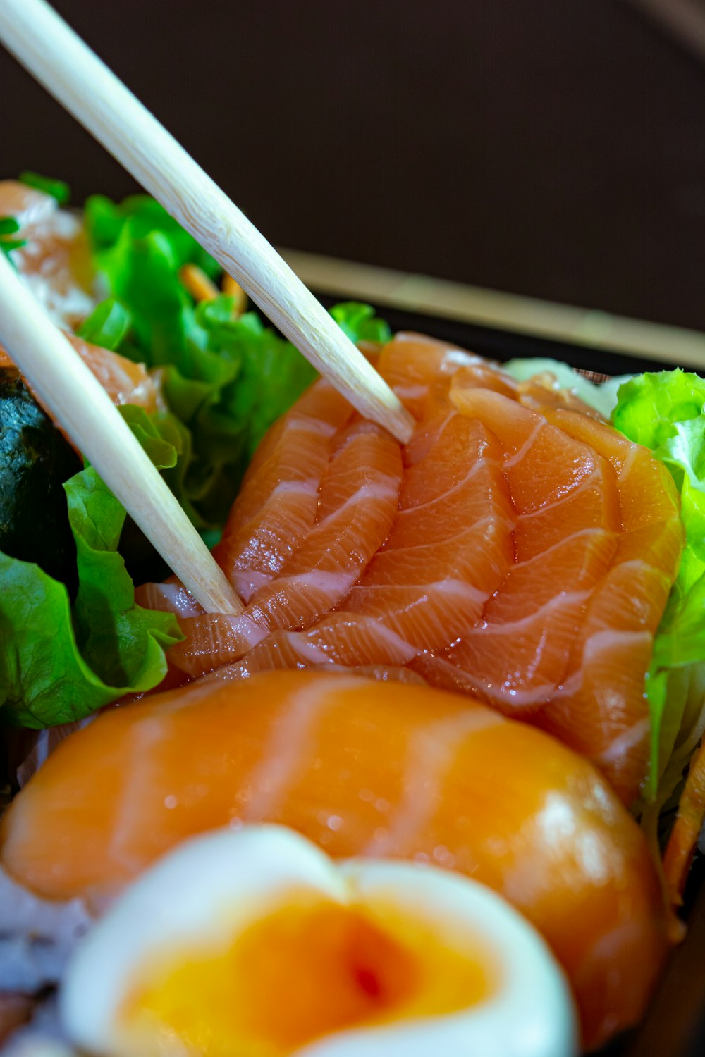 a close up of a plate of food with chopsticks