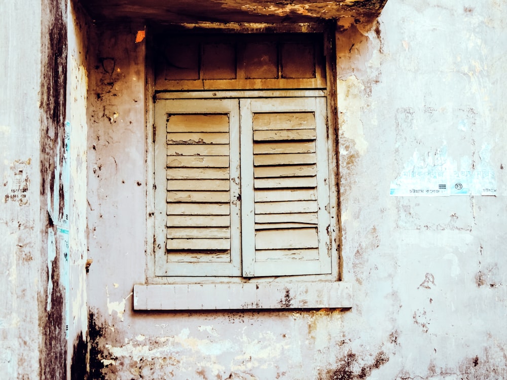 an old building with a window and shutters