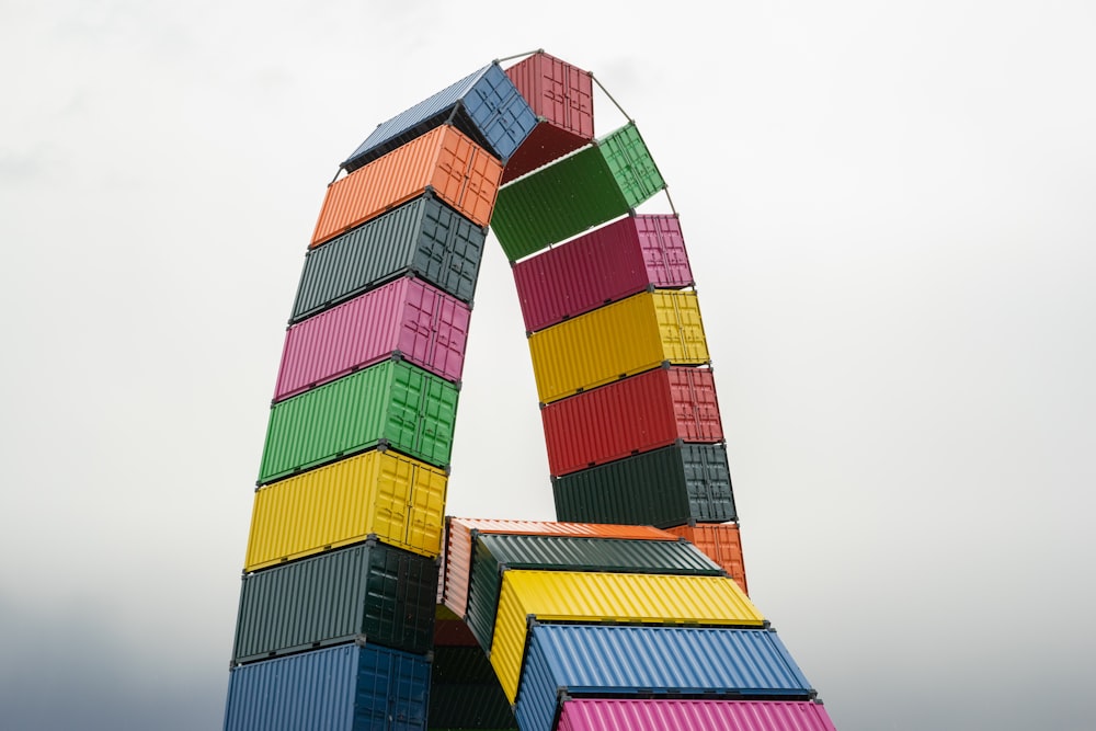 a colorful sculpture made of containers on a cloudy day