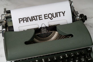 a close up of a typewriter with a paper that reads private equity
