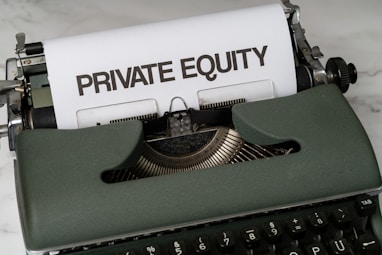 a close up of a typewriter with a paper that reads private equity