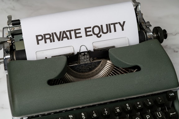a close up of a typewriter with a paper that reads private equity