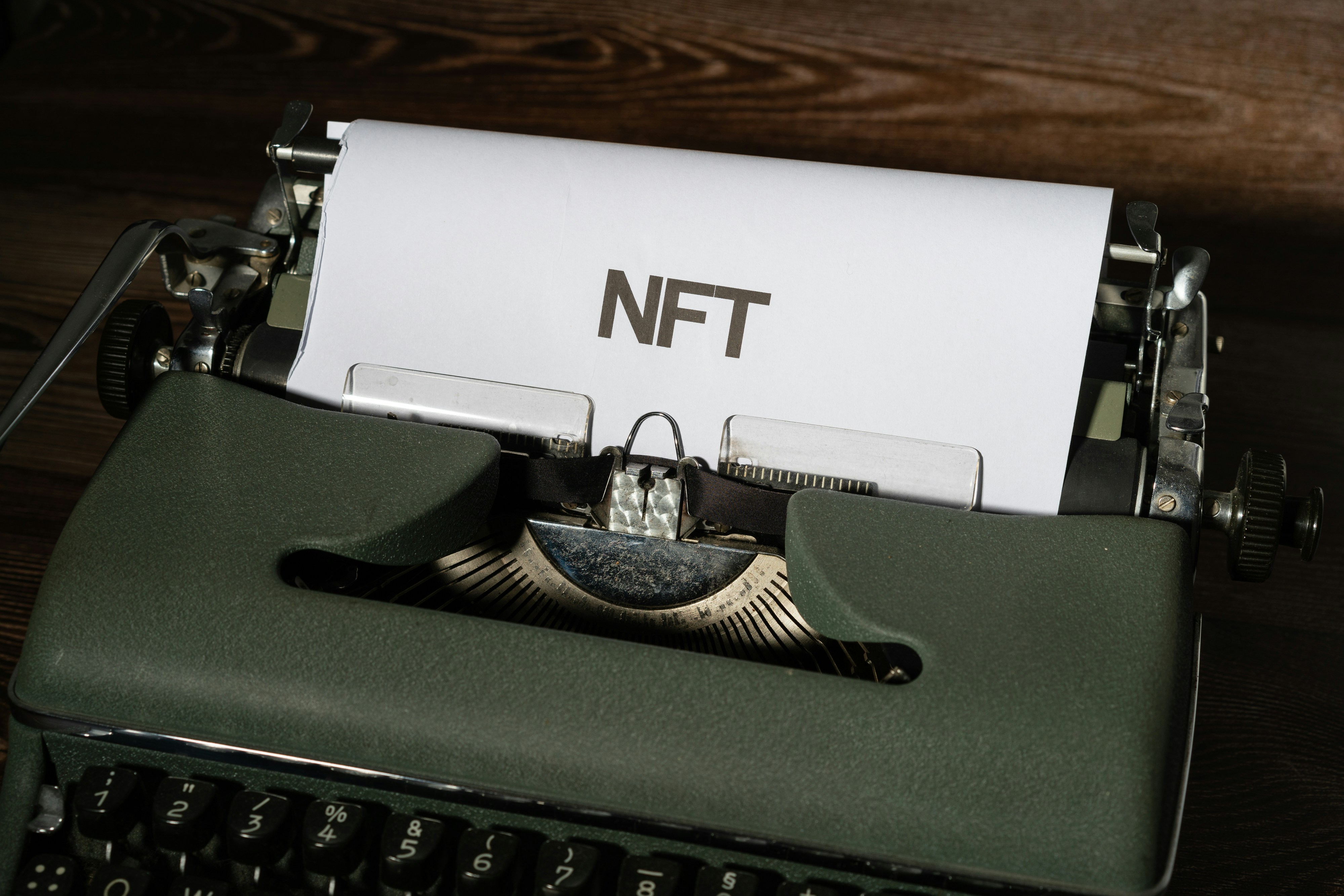 Typewriter with the acronym NFT on a piece of paper