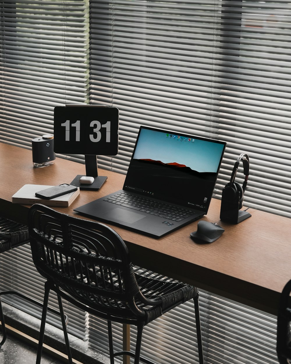 a laptop computer sitting on top of a wooden desk