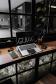 An AI assistant device on a desk next to a notebook and coffee cup in natural light