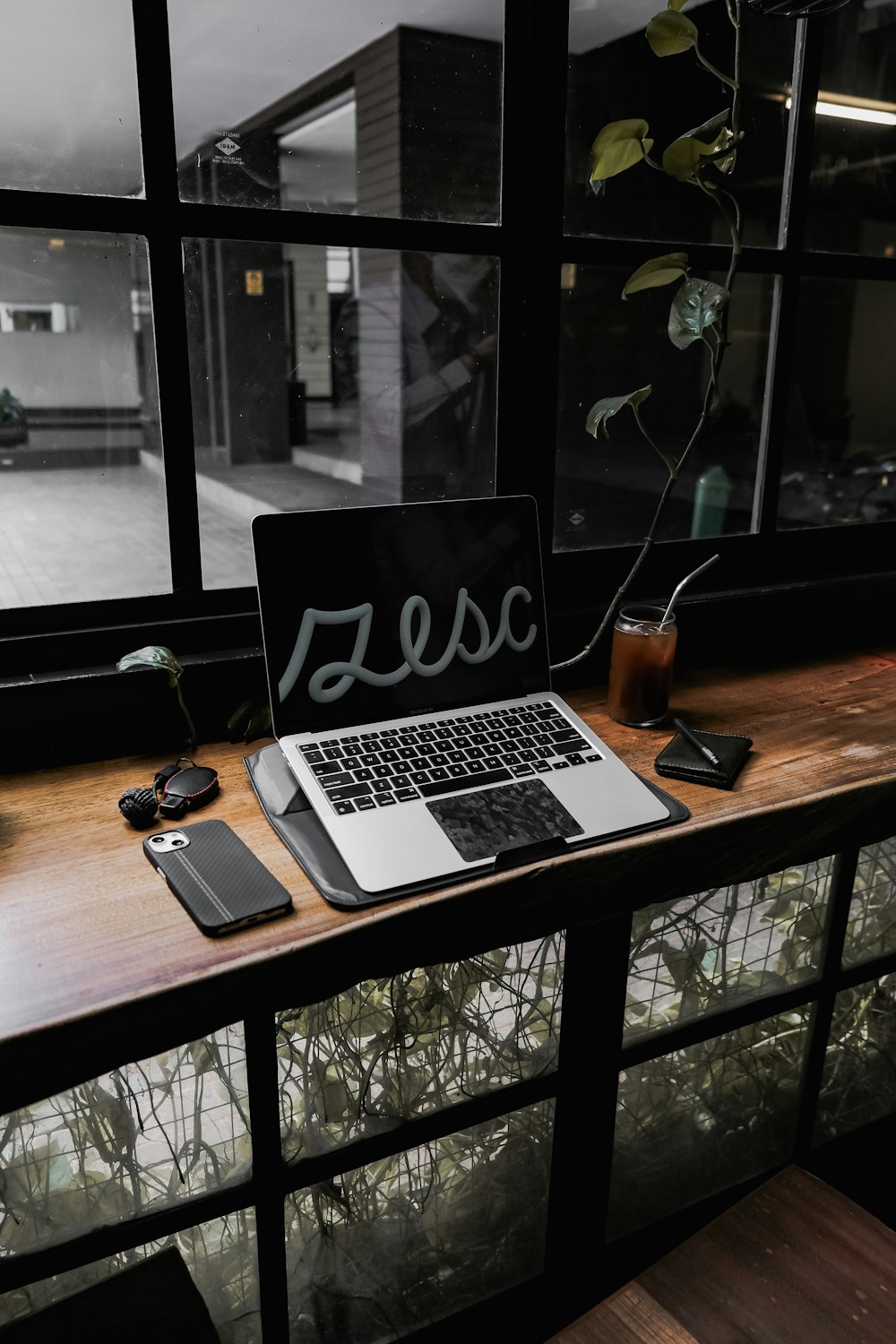 a laptop computer sitting on top of a wooden desk