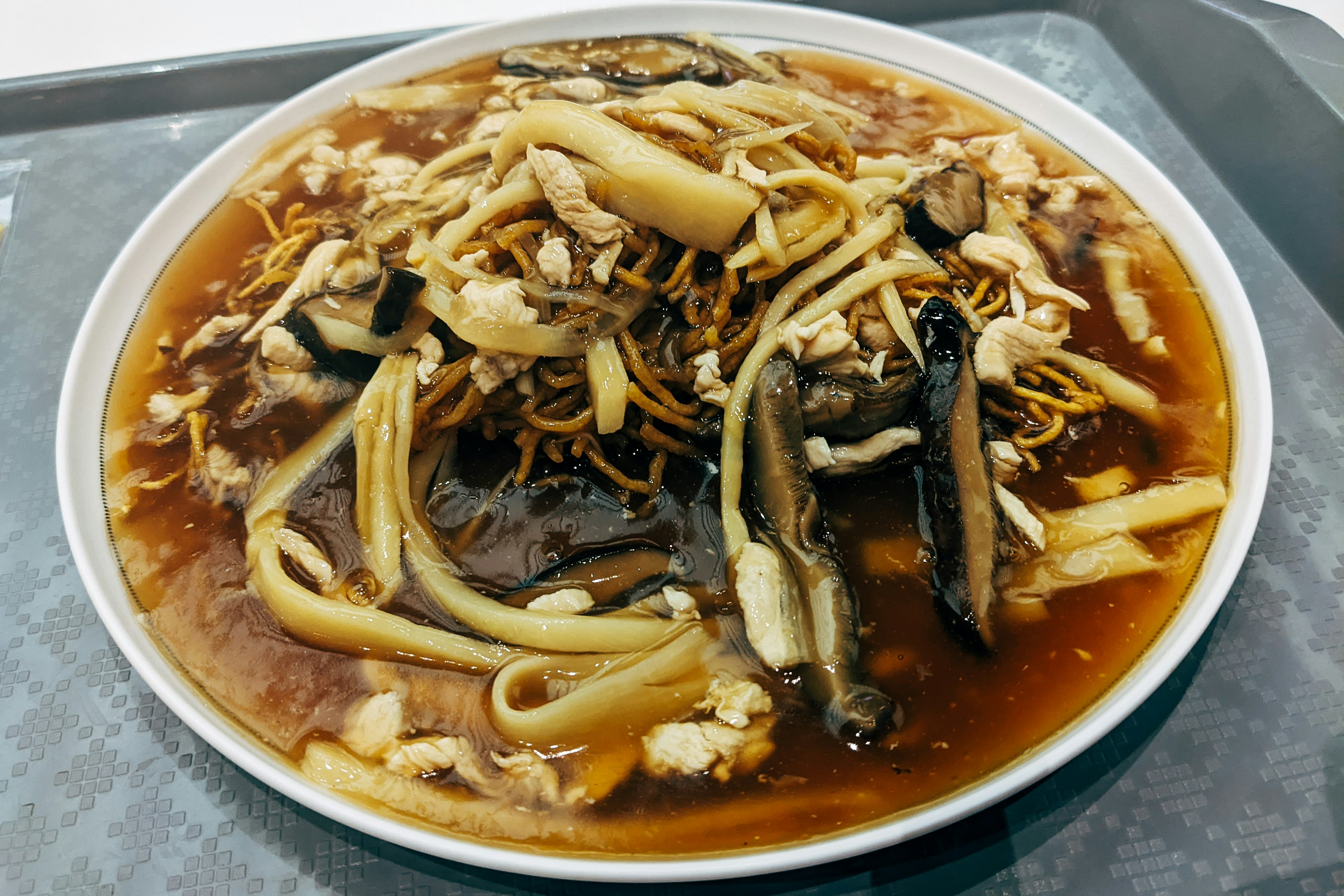 a bowl of noodles with mushrooms and sauce