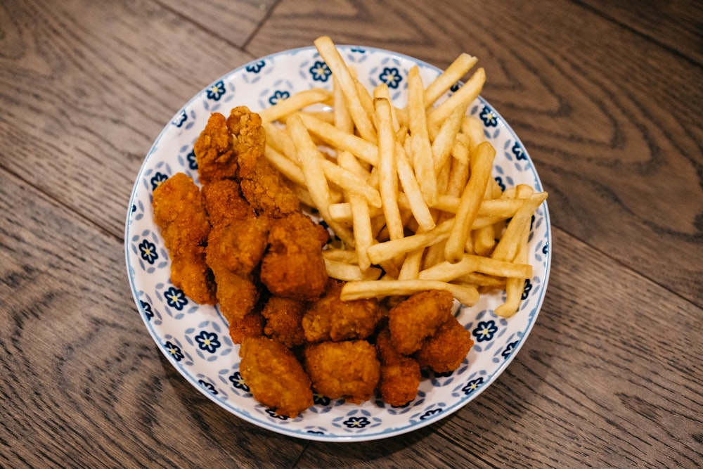 a plate of fried chicken and french fries