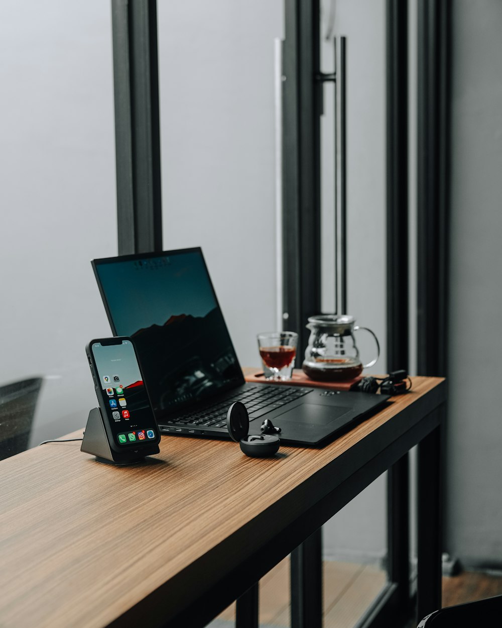 a laptop computer sitting on top of a wooden table