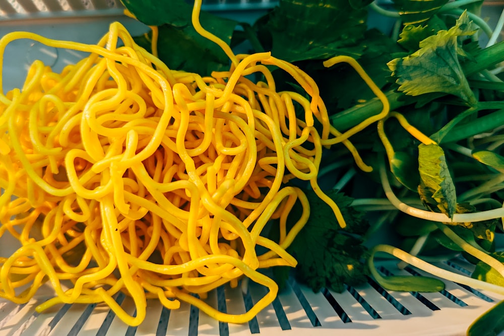a pile of yellow noodles sitting on top of a table