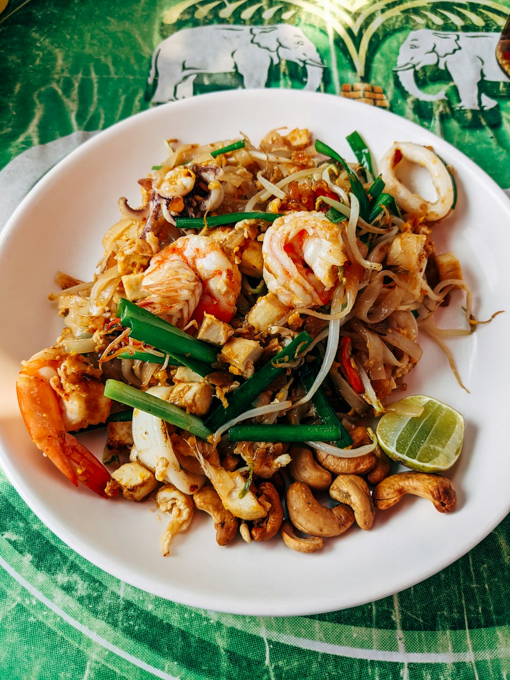 a white plate topped with shrimp and veggies