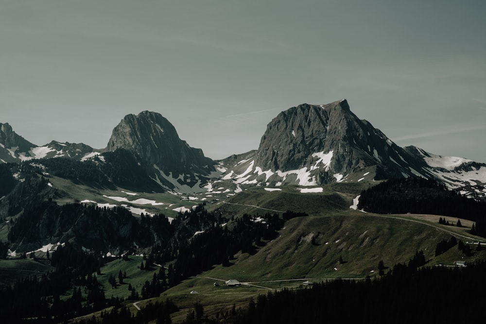 a mountain range with snow covered mountains in the background