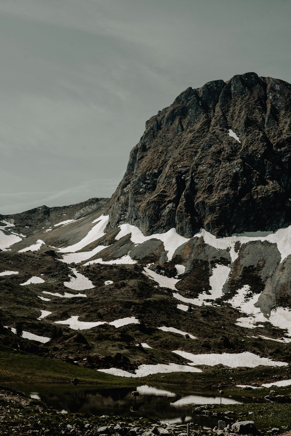 a mountain covered in snow with a sky background