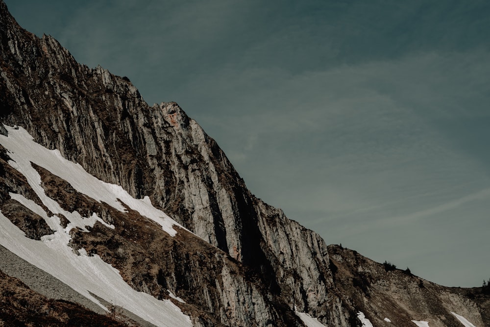 a man riding skis down the side of a snow covered mountain