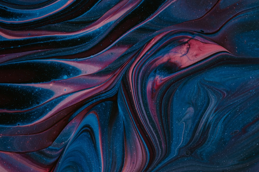 a close up of a blue and purple swirled background
