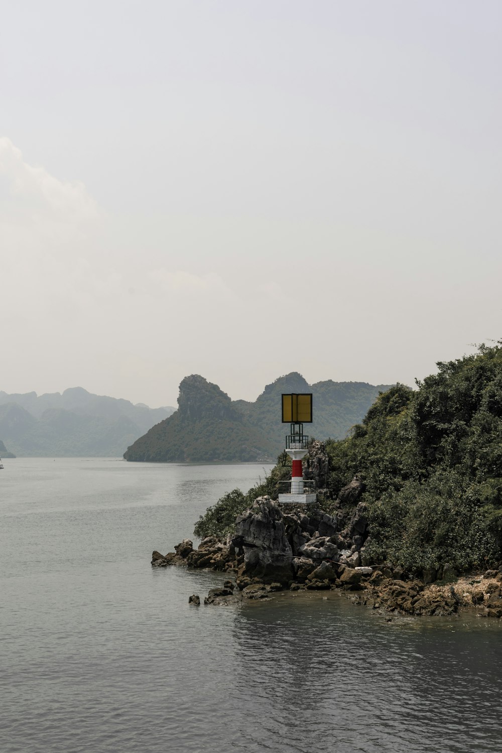 a sign on a small island in the middle of a body of water