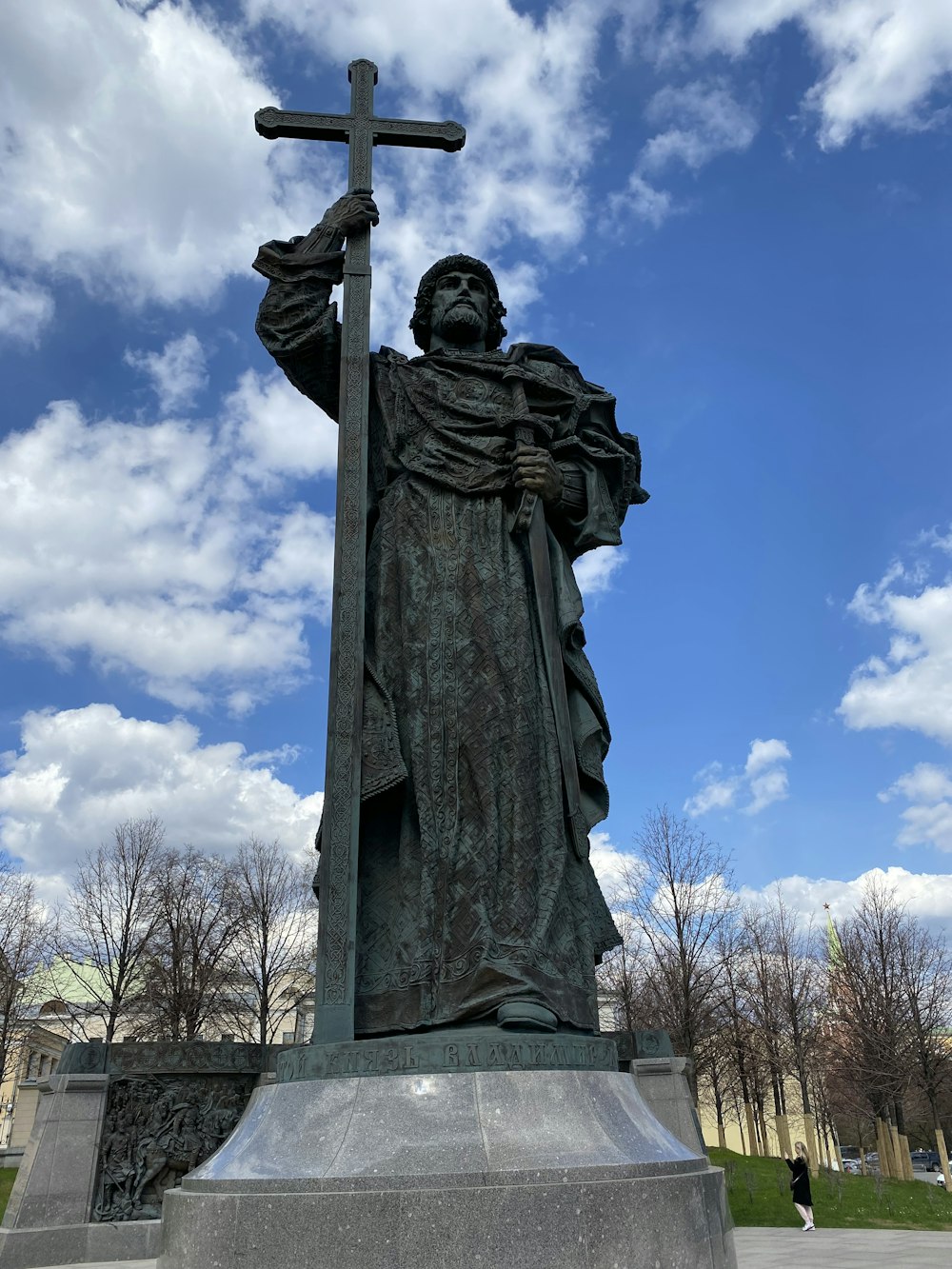 a statue of a person holding a cross