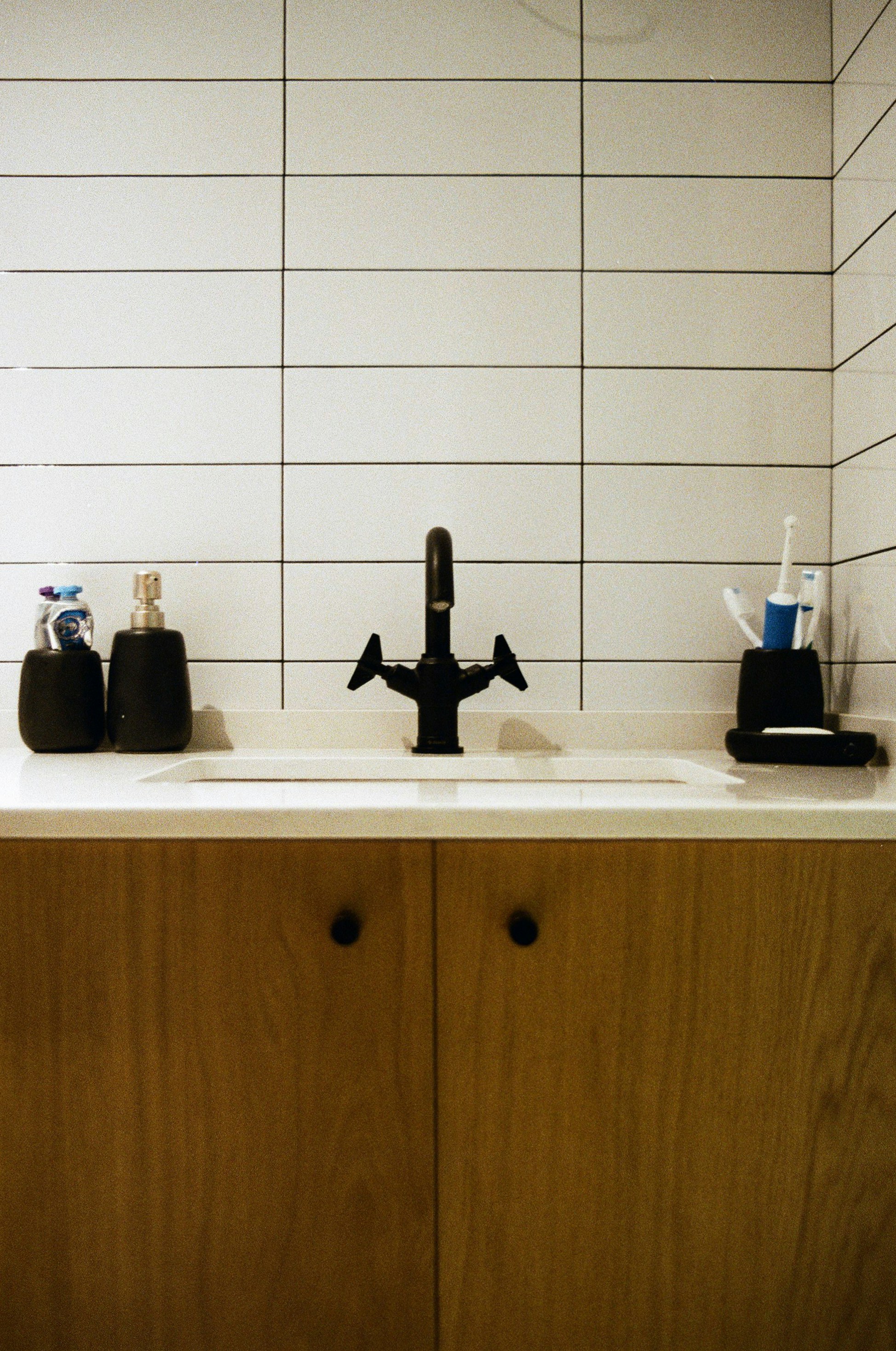 a kitchen sink with a faucet and soap dispenser