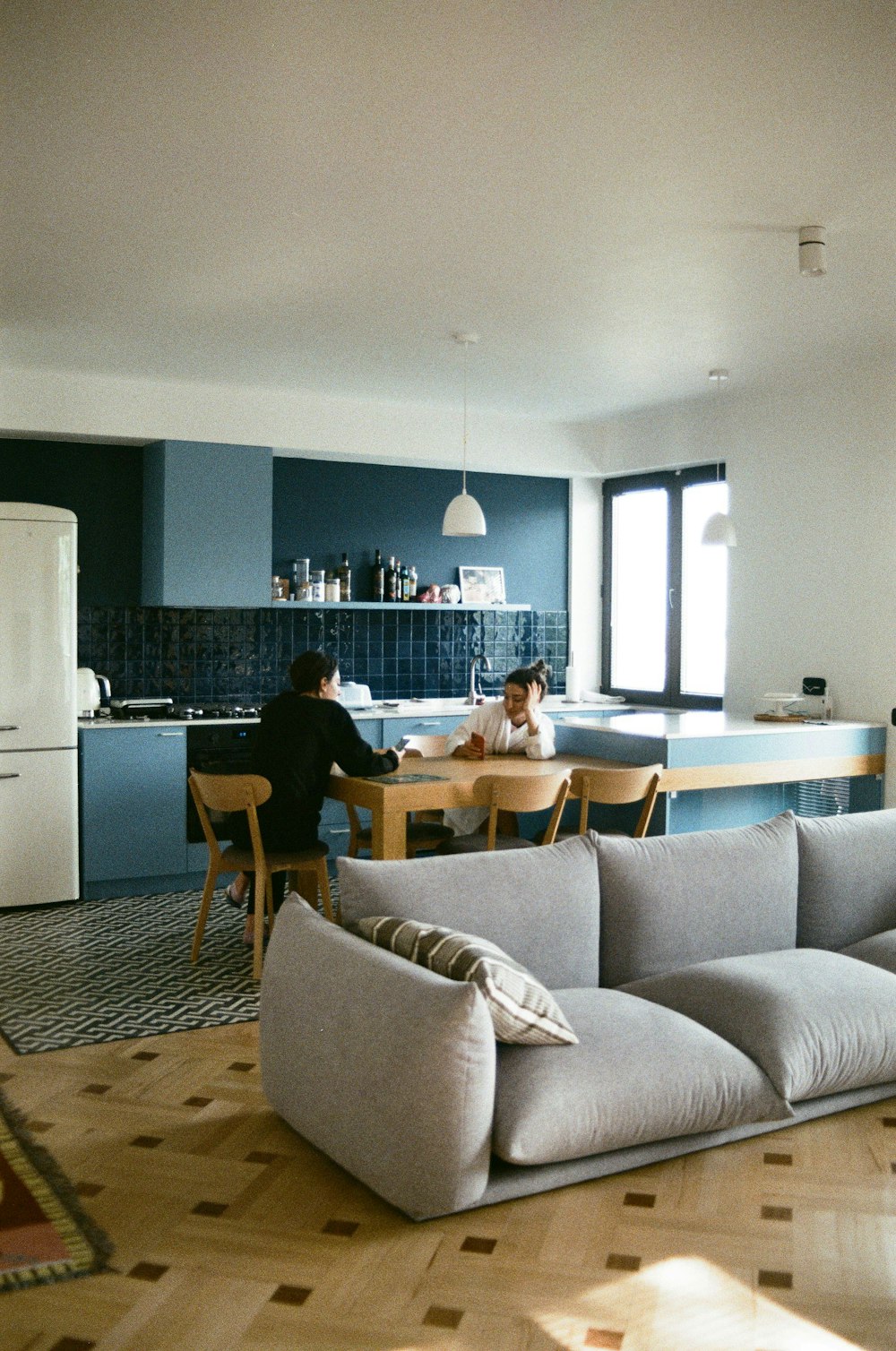 a couple of people sitting at a table in a room