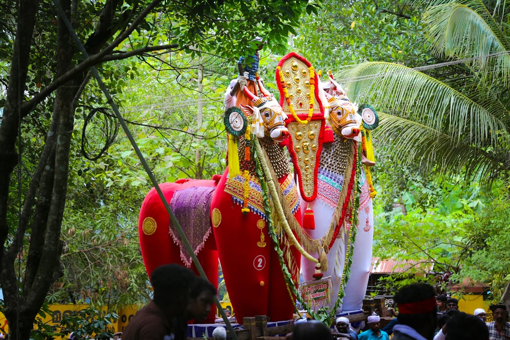 a large statue of an elephant in the middle of a forest