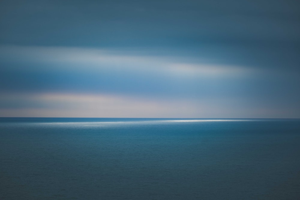 a large body of water under a cloudy sky