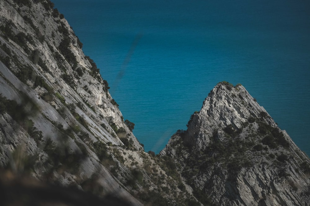 a mountain with a body of water in the background