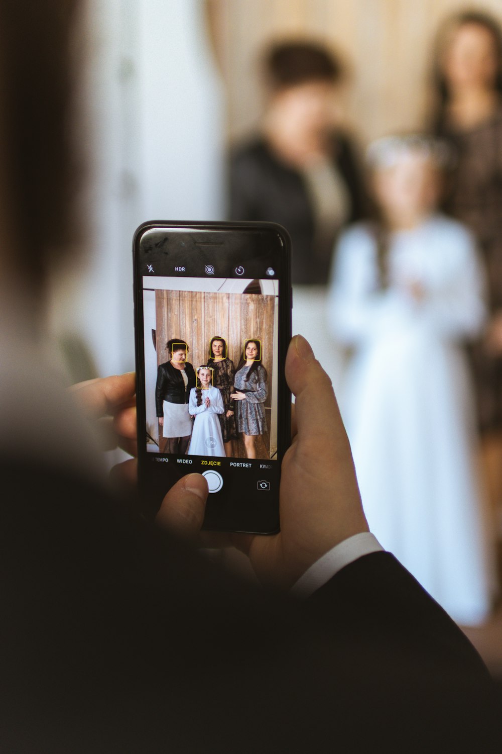 a person taking a picture of a group of people