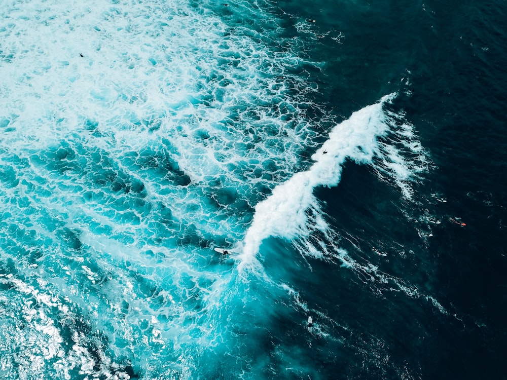 a person riding a surfboard on a wave in the ocean