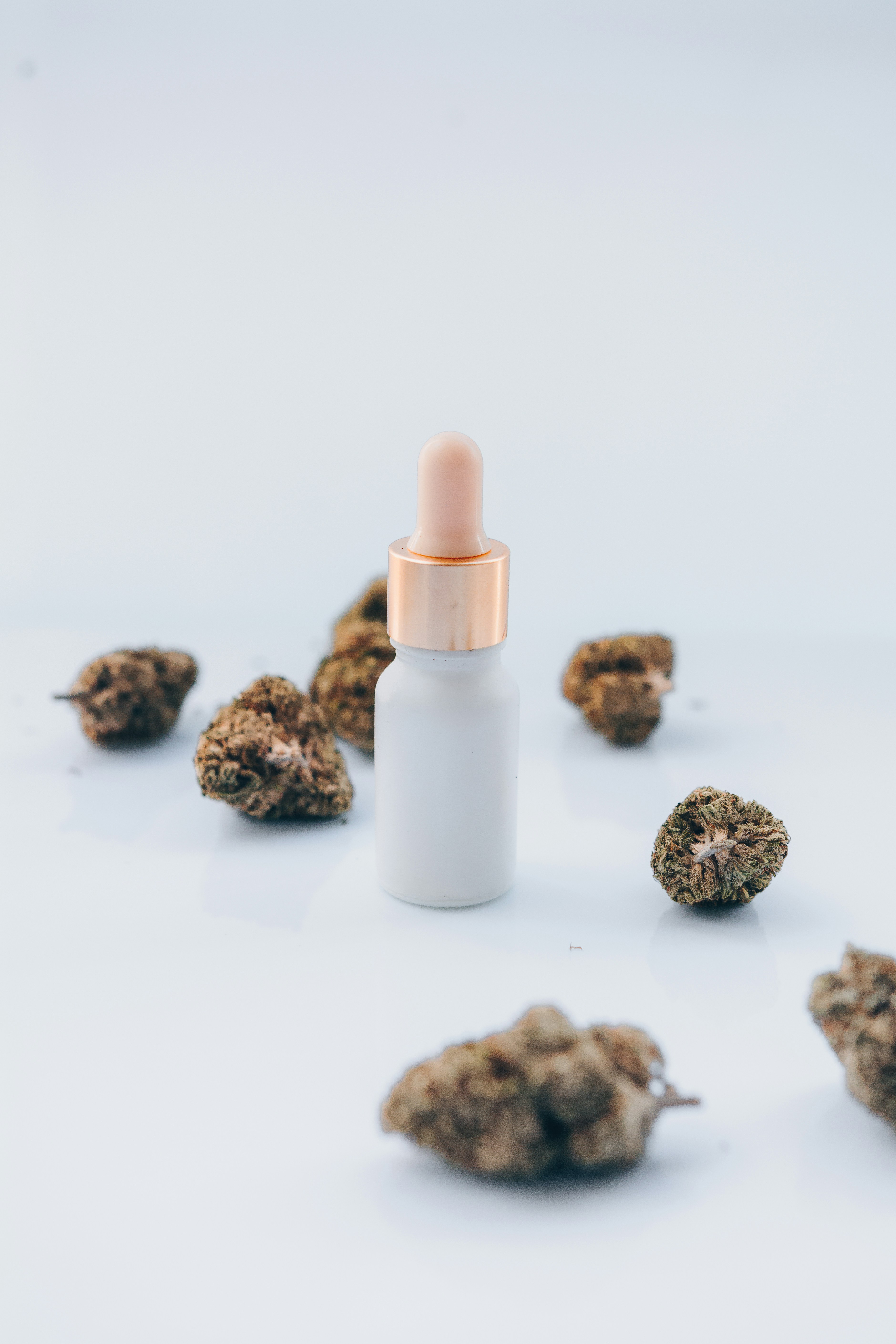 a white bottle filled with a small amount of weed