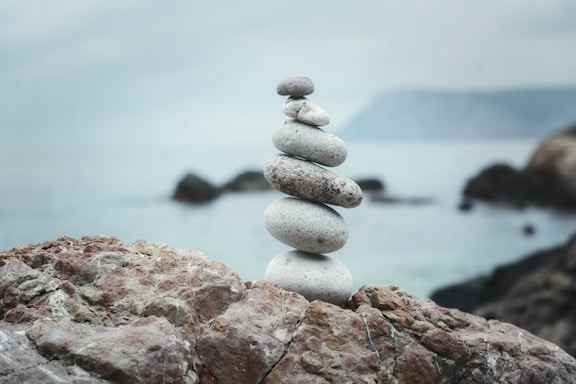 a stack of rocks sitting on top of a rocky beach