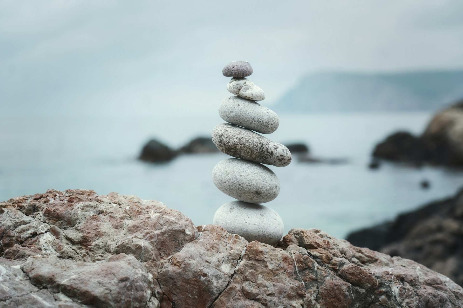 a stack of rocks sitting on top of a rocky beach